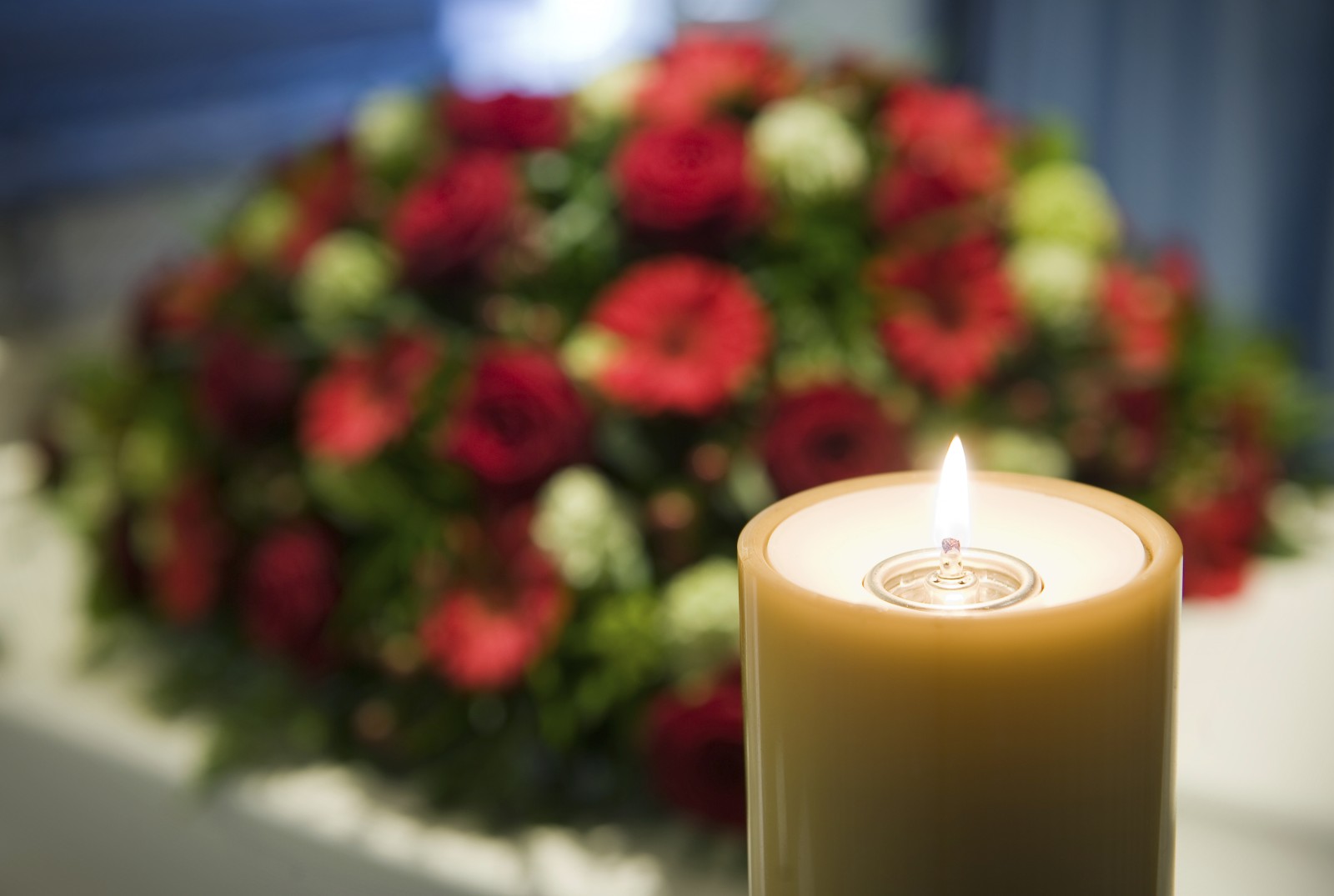 istock-candle-flower-funeral-e1457724228315